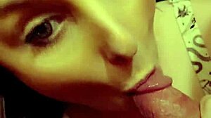 Redhead milf eagerly sucking on a throbbing hard cock in close-up view.