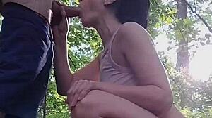 She sucks his cock in the forest while amused by honking