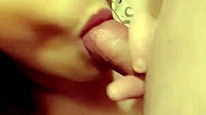 Redhead milf eagerly sucking on a throbbing hard cock in close-up view.