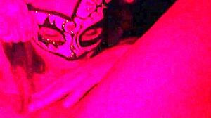 Masked in the red light sucking on something