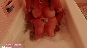 kity hudson enjoys bath tub time with her curvy figure