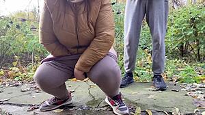 Curvy milf squats and pisses outdoors