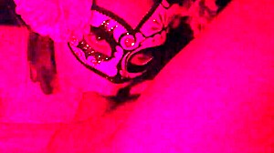 Masked in the red light sucking on something
