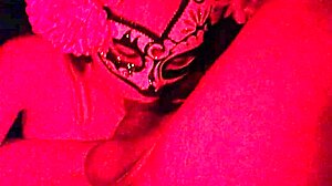 Masked in the red light sucking on something