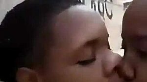 two liberian lesbians kissing passionately in an unfinished building