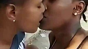 two liberian lesbians kissing passionately in an unfinished building