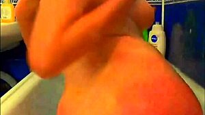 tattooed model plays with glass dildo