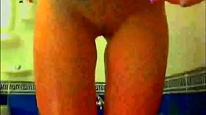 tattooed model plays with glass dildo