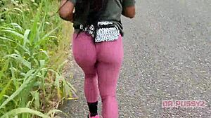 Big ass ebony in leggings running alone in the forest.