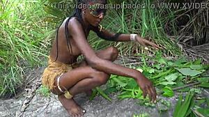 hot african native woman prepares a meal in the jungle kitchen