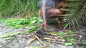 hot african native woman prepares a meal in the jungle kitchen