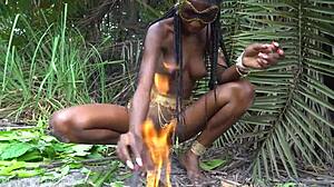 hot african native woman prepares a meal in the jungle kitchen