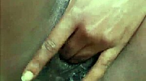 Horny ebony woman pisses publicly in wet outdoor spot