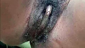 Horny ebony woman pisses publicly in wet outdoor spot