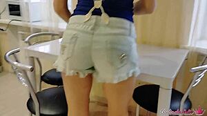 housewife enjoys a meal on the table and plays with dessert in mouth