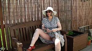 Naughty girl strips naked in the garden, feeling free outdoors.