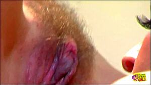 Classic lesbian babes in high heels kiss and suck on a glass sex toy together