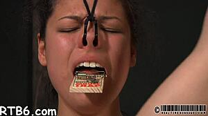 caged beauty gets a lusty whipping for her smooth butt