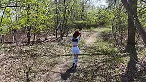 Young angler girl in fishnets and miniskirt moans during outdoor orgasm in forest