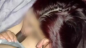 Redhead watches movies while sucking neighbor's dick