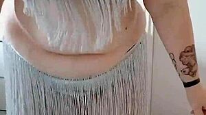 A BBW with a big ass performs an enticing belly dance on stage