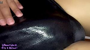 Watch me slip into this dark blue swimsuit with lotion for a slippery feel.