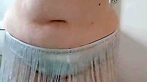 A BBW with a big ass performs an enticing belly dance on stage