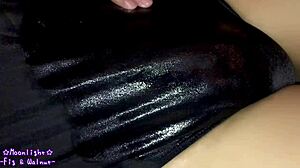 Watch me slip into this dark blue swimsuit with lotion for a slippery feel.