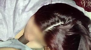 Redhead watches movies while sucking neighbor's dick