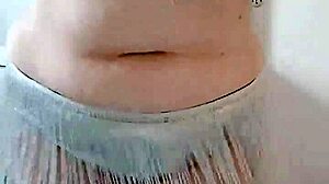 A BBW with a big ass performs an enticing belly dance on stage