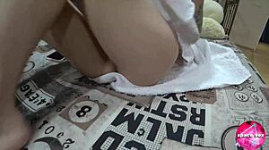 Cute teen plays pussy while parents watch tv nearby