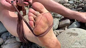 goddess hikes up leggings to reveal her dirty torn pantyhose nylon feet toes close up by the river