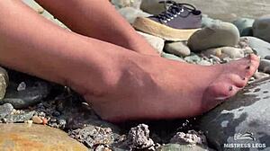 goddess hikes up leggings to reveal her dirty torn pantyhose nylon feet toes close up by the river