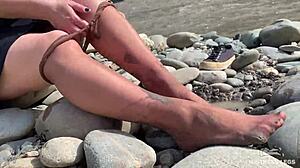 goddess hikes up leggings to reveal her dirty torn pantyhose nylon feet toes close up by the river