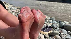 goddess hikes up leggings to reveal her dirty torn pantyhose nylon feet toes close up by the river