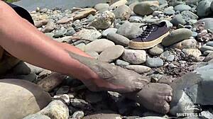 goddess hikes up leggings to reveal her dirty torn pantyhose nylon feet toes close up by the river