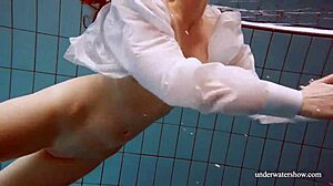 Lola dives underwater her big natural tits swaying seductively in the pool