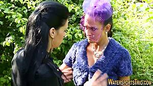 Outdoor lesbians in stockings finger and toy each other with golden shower fetish