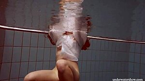 Lola dives underwater her big natural tits swaying seductively in the pool