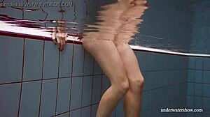 Lola dives underwater her big natural tits swaying seductively in the pool