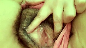 mature milf in lingerie touches herself close-up while watching homemade porn