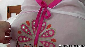 whoa, check this big-titted granny moaning as photographer fingers her wet pussy