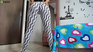 fitness model with big ass does squats in tight leggings showing off her athletic legs and natural tits