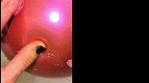 tattooed girl pops balloons in bubbly bath
