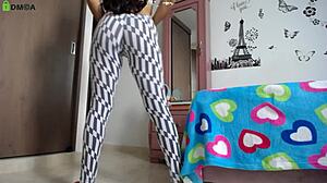 fitness model with big ass does squats in tight leggings showing off her athletic legs and natural tits