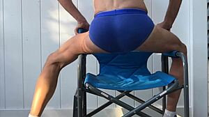 skinny legs stretch deep in blue briefs on chair