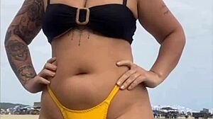 Young african usa girl in tight yellow bikini splitting swollen pussy on beach