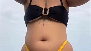 Young african usa girl in tight yellow bikini splitting swollen pussy on beach