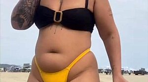 Young african usa girl in tight yellow bikini splitting swollen pussy on beach