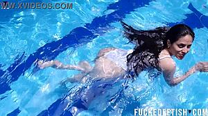 Helen Star's masked pool dive reveals wet pussy.